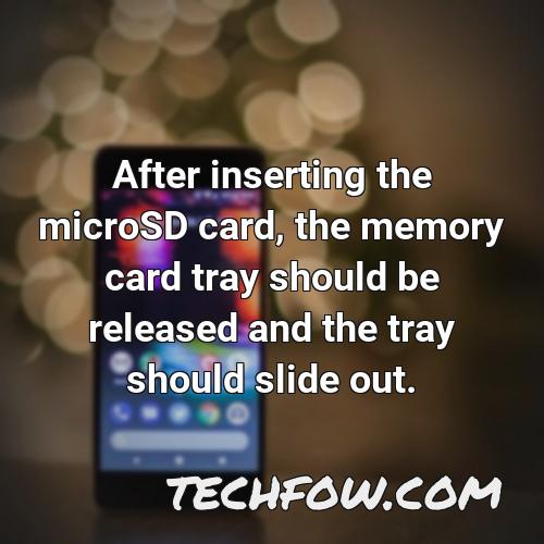 after inserting the microsd card the memory card tray should be released and the tray should slide out