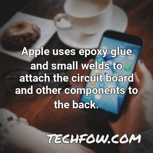 apple uses epoxy glue and small welds to attach the circuit board and other components to the back