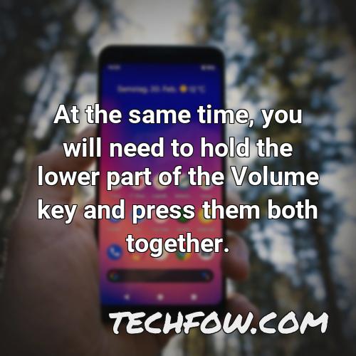 at the same time you will need to hold the lower part of the volume key and press them both together