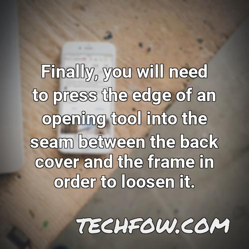 finally you will need to press the edge of an opening tool into the seam between the back cover and the frame in order to loosen it