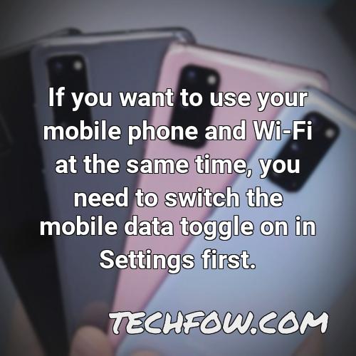 if you want to use your mobile phone and wi fi at the same time you need to switch the mobile data toggle on in settings first