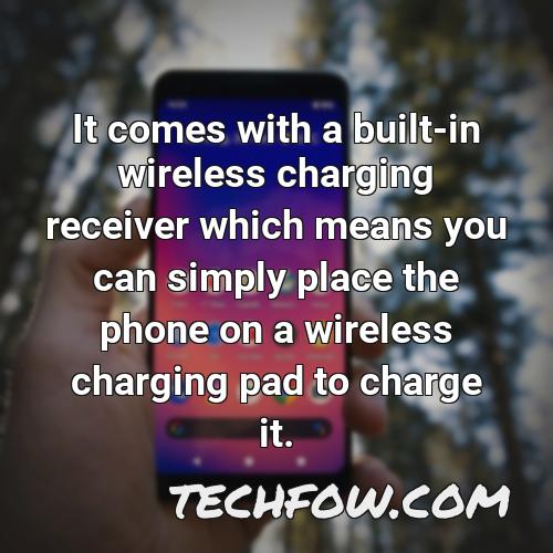 it comes with a built in wireless charging receiver which means you can simply place the phone on a wireless charging pad to charge it