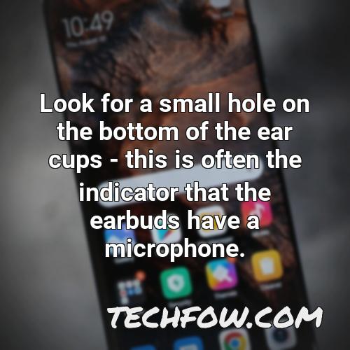 look for a small hole on the bottom of the ear cups this is often the indicator that the earbuds have a microphone