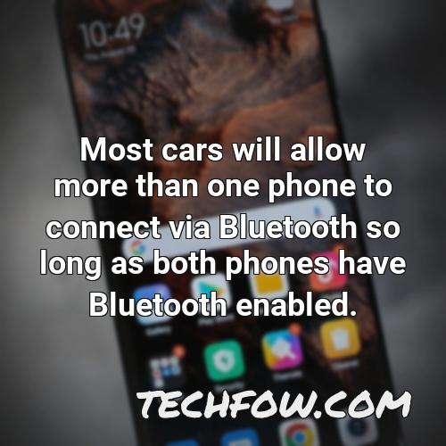 most cars will allow more than one phone to connect via bluetooth so long as both phones have bluetooth enabled