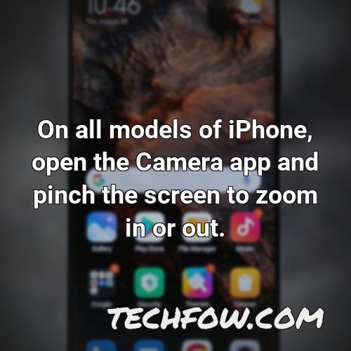 on all models of iphone open the camera app and pinch the screen to zoom in or out