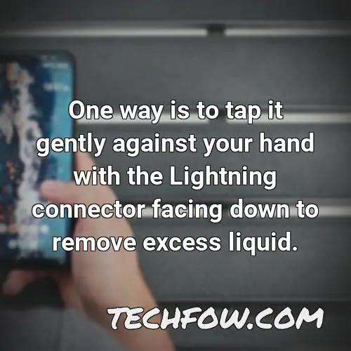one way is to tap it gently against your hand with the lightning connector facing down to remove excess liquid