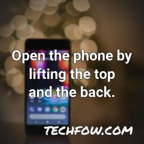 open the phone by lifting the top and the back