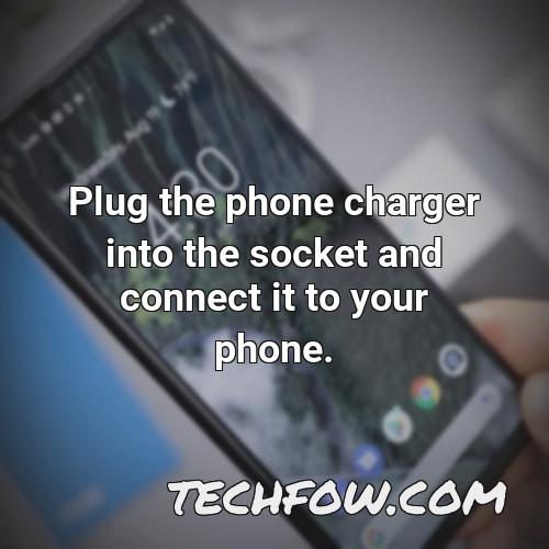 plug the phone charger into the socket and connect it to your phone