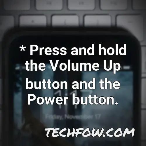 press and hold the volume up button and the power button