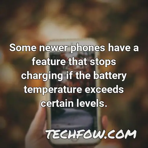 some newer phones have a feature that stops charging if the battery temperature exceeds certain levels