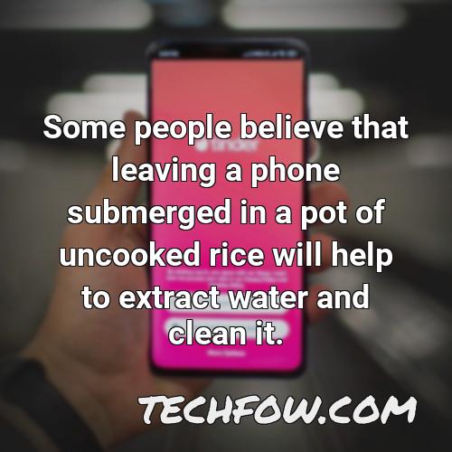 some people believe that leaving a phone submerged in a pot of uncooked rice will help to extract water and clean it