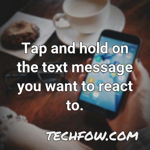 tap and hold on the text message you want to react to