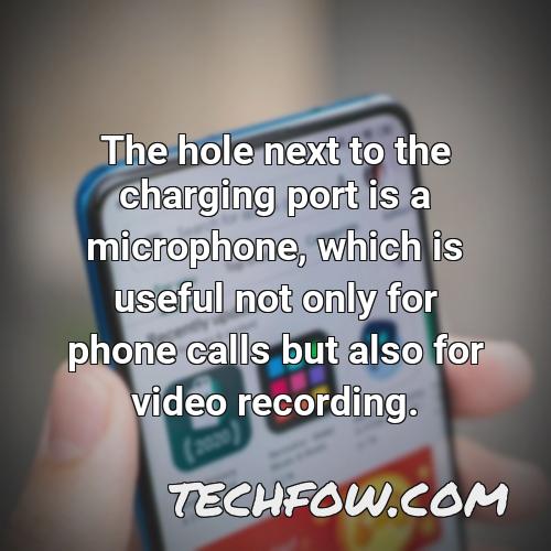 the hole next to the charging port is a microphone which is useful not only for phone calls but also for video recording