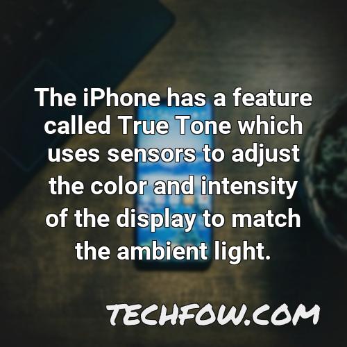 the iphone has a feature called true tone which uses sensors to adjust the color and intensity of the display to match the ambient light