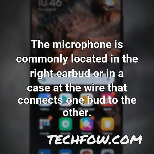 the microphone is commonly located in the right earbud or in a case at the wire that connects one bud to the other