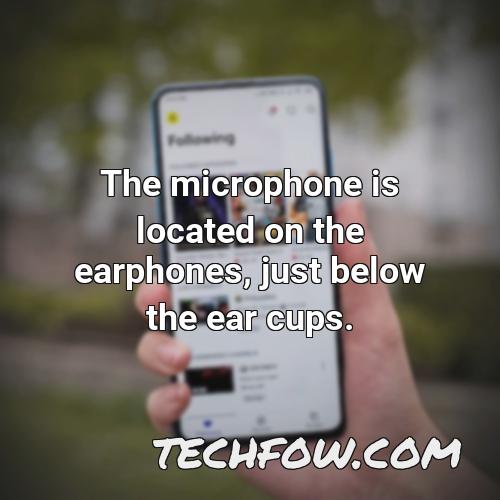 the microphone is located on the earphones just below the ear cups