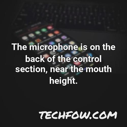 the microphone is on the back of the control section near the mouth height