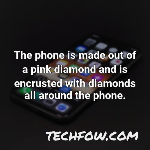 the phone is made out of a pink diamond and is encrusted with diamonds all around the phone