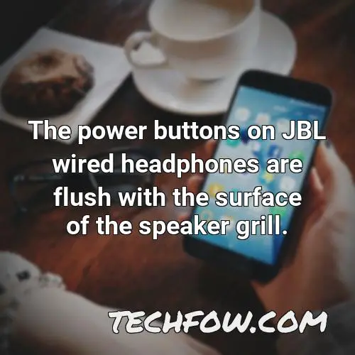 the power buttons on jbl wired headphones are flush with the surface of the speaker grill