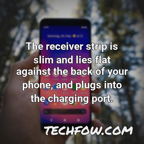 the receiver strip is slim and lies flat against the back of your phone and plugs into the charging port