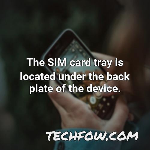 the sim card tray is located under the back plate of the device
