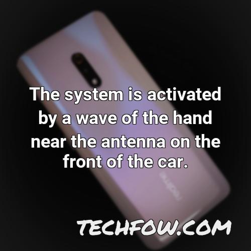 the system is activated by a wave of the hand near the antenna on the front of the car