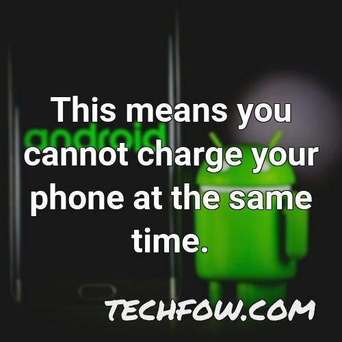 this means you cannot charge your phone at the same time