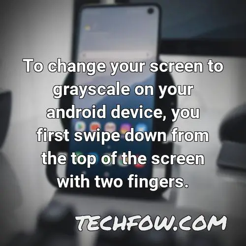 to change your screen to grayscale on your android device you first swipe down from the top of the screen with two fingers