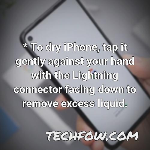 to dry iphone tap it gently against your hand with the lightning connector facing down to remove excess liquid 4