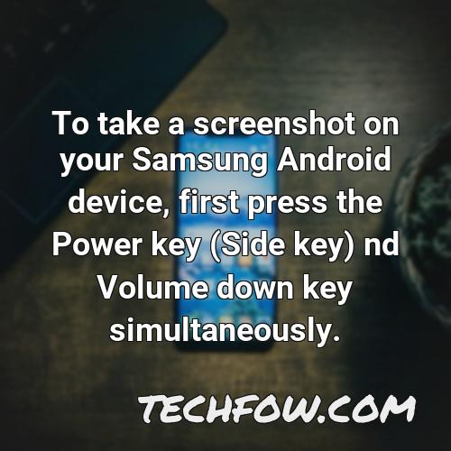 to take a screenshot on your samsung android device first press the power key side key nd volume down key simultaneously
