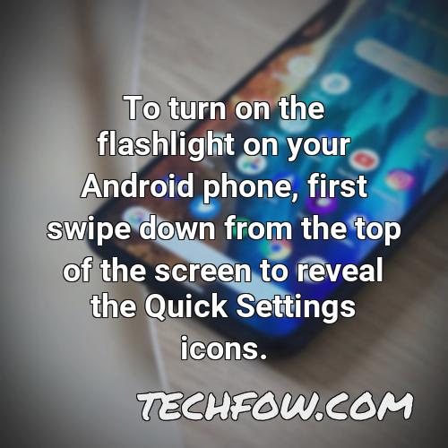 to turn on the flashlight on your android phone first swipe down from the top of the screen to reveal the quick settings icons