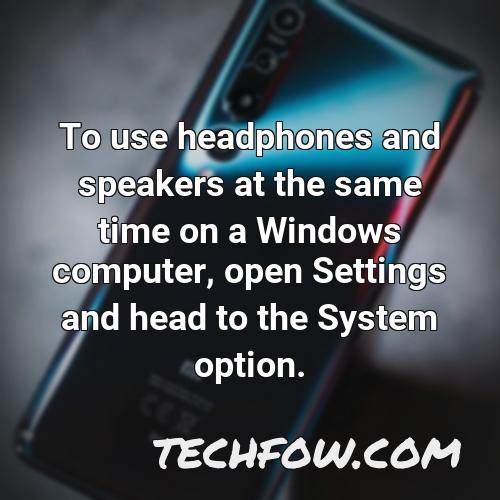 to use headphones and speakers at the same time on a windows computer open settings and head to the system option