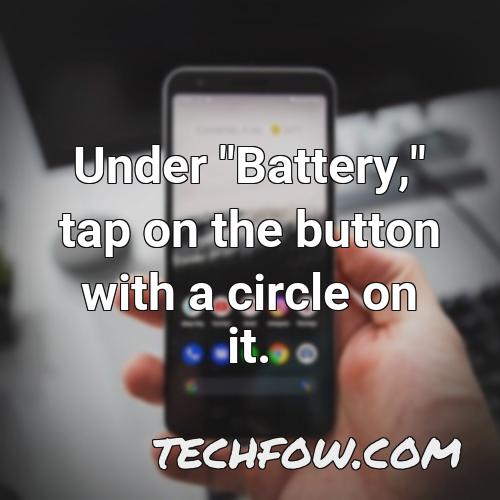 under battery tap on the button with a circle on it