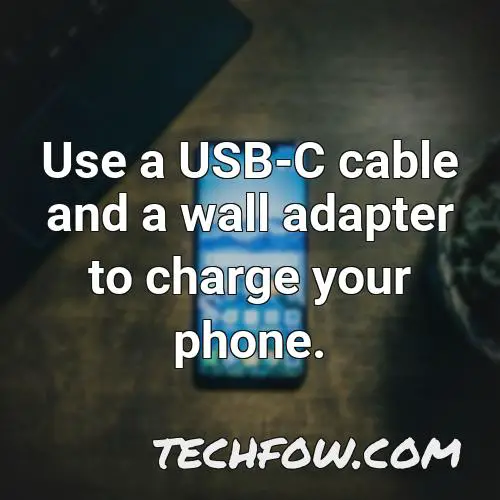 use a usb c cable and a wall adapter to charge your phone