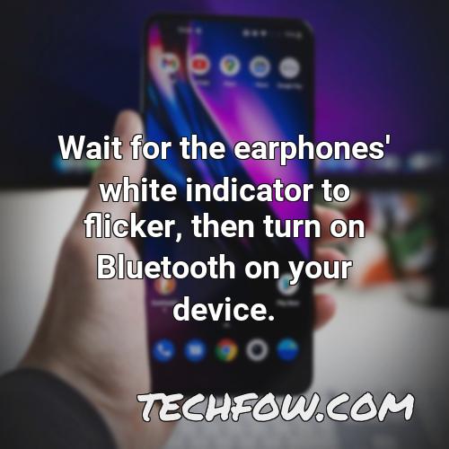 wait for the earphones white indicator to flicker then turn on bluetooth on your device