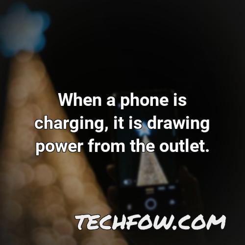 when a phone is charging it is drawing power from the outlet