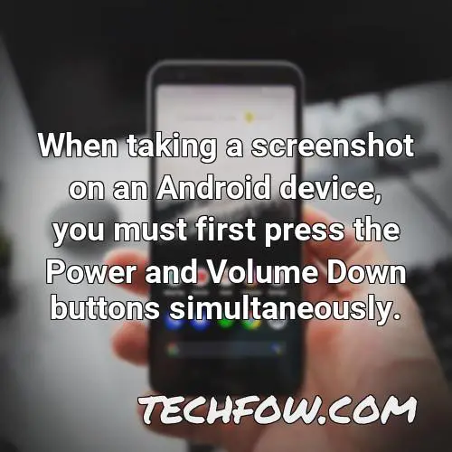 when taking a screenshot on an android device you must first press the power and volume down buttons simultaneously