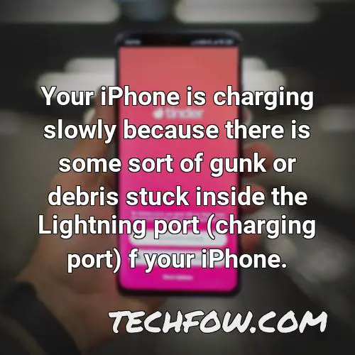 your iphone is charging slowly because there is some sort of gunk or debris stuck inside the lightning port charging port f your iphone