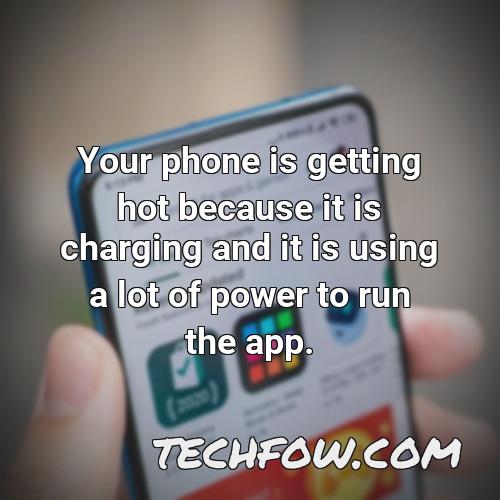 your phone is getting hot because it is charging and it is using a lot of power to run the app