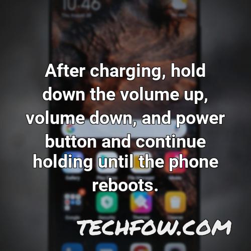 after charging hold down the volume up volume down and power button and continue holding until the phone reboots