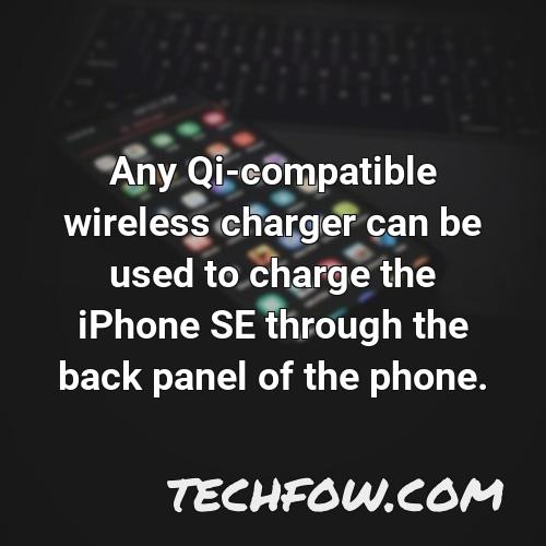 any qi compatible wireless charger can be used to charge the iphone se through the back panel of the phone