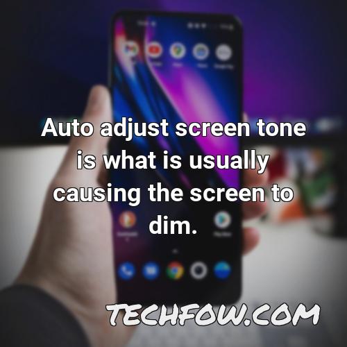 auto adjust screen tone is what is usually causing the screen to dim