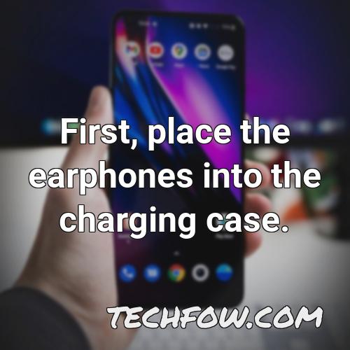 first place the earphones into the charging case