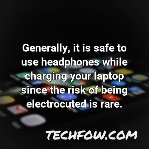 generally it is safe to use headphones while charging your laptop since the risk of being electrocuted is rare