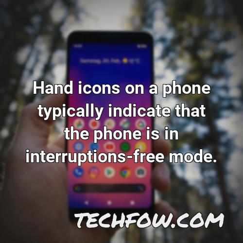 hand icons on a phone typically indicate that the phone is in interruptions free mode