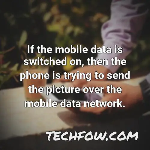 if the mobile data is switched on then the phone is trying to send the picture over the mobile data network