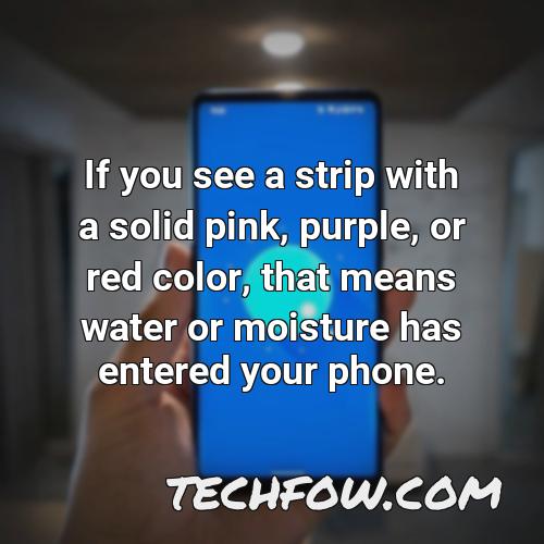 if you see a strip with a solid pink purple or red color that means water or moisture has entered your phone