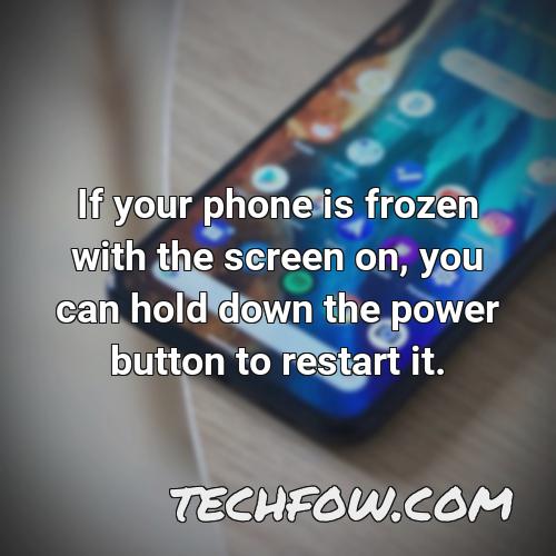 if your phone is frozen with the screen on you can hold down the power button to restart it 1