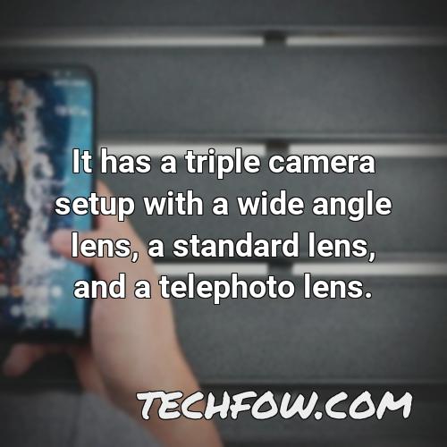 it has a triple camera setup with a wide angle lens a standard lens and a telephoto lens