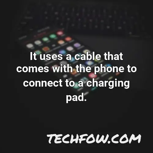 it uses a cable that comes with the phone to connect to a charging pad